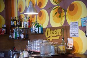 a bar with a counter with bottles of alcohol at Sunflower City Student Hostel & Bar in Rimini