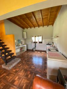 a kitchen with wooden floors and a kitchen with a stove at Balcón de Barcena in Volcán