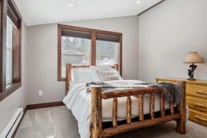 a bedroom with a wooden bed and a window at Philipsburg Family & Couples Cabin Ski Hike Relax in Philipsburg