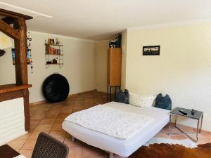 a bedroom with a white bed and a table at FeWo Sildemow - 3 Zimmer mit Garten und Parkplatz in Papendorf +12 photos