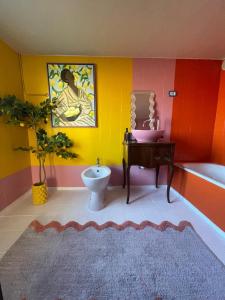 a bathroom with a toilet and a sink and a tub at Casa Zuccaro in Valduggia +6 photos