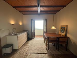 a kitchen and dining room with a table and a sink at Casa Zuccaro in Valduggia