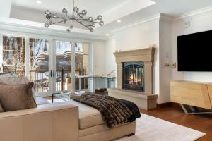 a living room with a fireplace and a tv at Ritz Carlton Luxe 3 bed 4 bath in Vail
