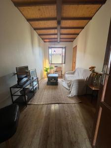 a living room with a bed and a table at Casa Zuccaro in Valduggia