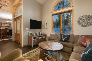 a living room with a couch and a table at Stunning Mountain Retreat with View and Private Hot Tub in Tabernash