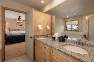 a bathroom with two sinks and a bedroom at Stunning Mountain Retreat with View and Private Hot Tub in Tabernash +38 photos
