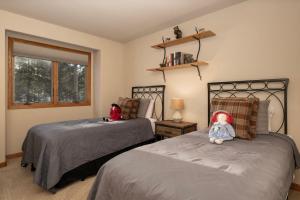 a bedroom with two beds with dolls sitting on them at Stunning Mountain Retreat with View and Private Hot Tub in Tabernash