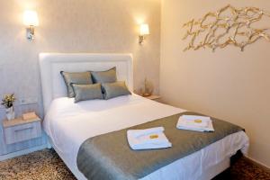 a bedroom with a bed with two towels on it at Sykea Luxury Apartment in Xylokastro
