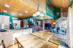 a kitchen with a wooden table in a room at 32 Cabin Cluster Ln in Sunriver
