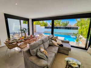 a living room with a couch and a table at Villa Murcia - Private heated pool & jacuzzi in Santiago de la Ribera