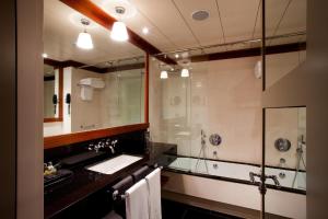 a bathroom with a sink and a shower at Hotel 1898 in Barcelona