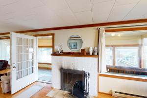 a living room with a fireplace and a window at Auntie's House in Rockaway Beach