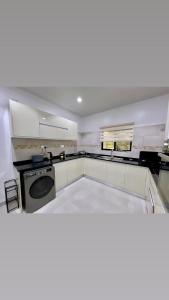 a kitchen with a dishwasher and a stove in it at Velvet Escapes in Lusaka +9 photos