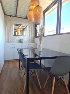 a dining room with a black table and chairs at Apartment in Flic en Flac of 68 m² with pool in Flic-en-Flac