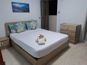 a bedroom with a large bed with white sheets and pillows at Apartment in Flic en Flac of 68 m² with pool in Flic-en-Flac