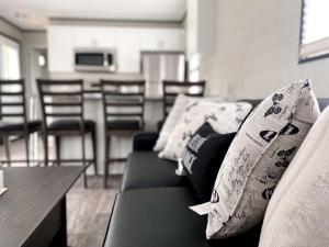 a living room with a couch and a table and chairs at The Balmoral at Duck Lake in Carden