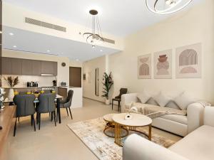 a living room with a couch and a table at Elegant 1BR I 1min walk to Burj Khalifa & Fountain in Dubai