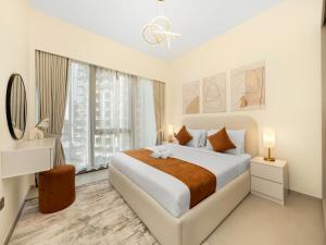 a white bedroom with a bed and a large window at Elegant 1BR I 1min walk to Burj Khalifa & Fountain in Dubai