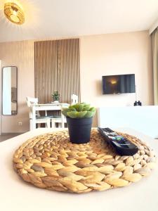 a living room with a table with a remote control at Duhnerherz Bestlage im Zentrum,am Strand Duhnen, Balkon mit Meerblick,Wlan Parkplatz und Fahrradabstellraum Bettwäsche und Handtücher inkl in Cuxhaven +20 photos