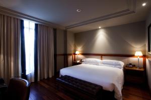 a hotel room with a large bed and a window at Hotel 1898 in Barcelona