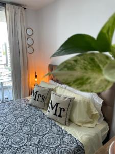 een slaapkamer met een bed met kussens erop bij Rosario SJ Loft in Rosario