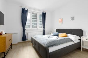 a bedroom with a bed and a window at 2 bedroom apartment with a terrace near the metro in Prague
