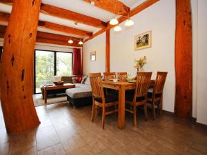 a living room with a wooden table and chairs at Ferienhaus Waldblick in Göhren-Lebbin in Göhren-Lebbin