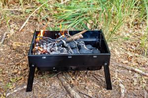 a black box filled with fire on the ground at Monoshez Bush Camp in Nsikazi