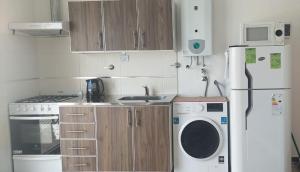 a kitchen with a refrigerator and a washing machine at Sur Bonito in Río Grande +15 photos