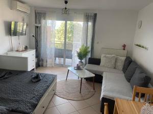 a living room with a couch and a table at Lovely apartment cosmopoli in Komotini