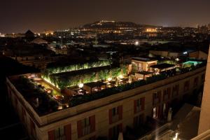 a building with plants on the roof at night at Hotel 1898 in Barcelona