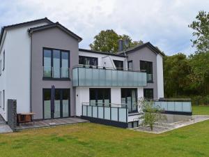 an exterior view of a house with a lawn at Exclusives Appartement auf Fehmarn in Petersdorf auf Fehmarn