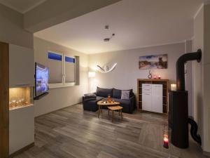 a living room with a couch and a table at Exclusives Appartement auf Fehmarn in Petersdorf auf Fehmarn
