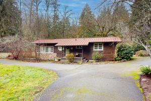 a small log cabin with a road in front of it at Molalla River Cottage in Molalla