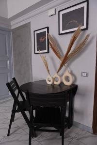 a black table with a vase on top of it at Belle Helen - Bright Independent Apartment in Cairo +40 photos