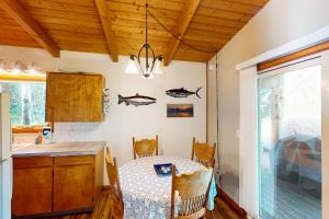 a kitchen with a table and a dining room at Herb's Hideaway in Twin Rocks