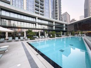 a large swimming pool in the middle of a building at Elegant 1BR I 1min walk to Burj Khalifa & Fountain in Dubai