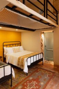 a bedroom with a large bed and a blue door at Casa Grullon, an Oasis in the Colonial Zone in Santo Domingo