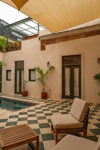 a patio with a checkered floor and a pool at Casa Grullon, an Oasis in the Colonial Zone in Santo Domingo