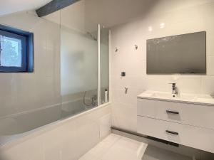 a white bathroom with a sink and a shower at Maison 3 chambres in Villemandeur +5 photos