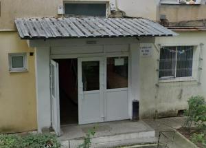 an entry to a house with a white door at The Box in Iaşi