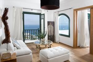 un soggiorno con divano bianco e tavolo di Tharroe of Mykonos Boutique Hotel a Mykonos Città