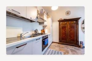 a kitchen with a sink and a stove top oven at Bilocale Desenzano in Desenzano del Garda