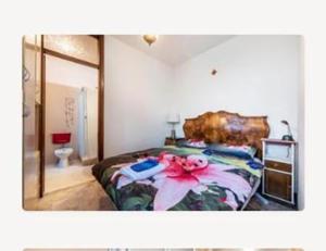 a bedroom with a bed with a flower on it at Bilocale Desenzano in Desenzano del Garda