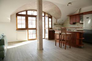 a kitchen with an archway in the middle of a room at Apartment Marilyn in Šumperk