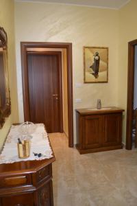 a room with a table and a cabinet and a door at B&B Visconti in Lido di Ostia
