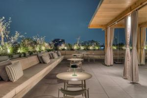 a rooftop patio with tables and chairs and lights at ONTO Alvaro Obregon Mexico City in Mexico City +57 photos