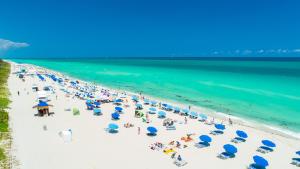 an overhead view of a beach with people and umbrellas at Oceanview Private Condo at The Setai -3504 in Miami Beach