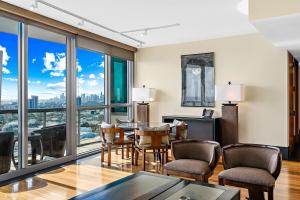 a living room with a table and chairs and windows at Oceanview Private Condo at The Setai -3504 in Miami Beach +27 photos