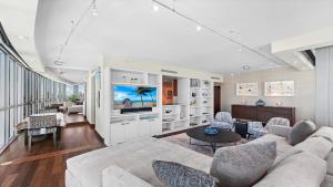 a living room with a couch and a tv at Oceanview Private Condo at The Setai -2202 in Miami Beach